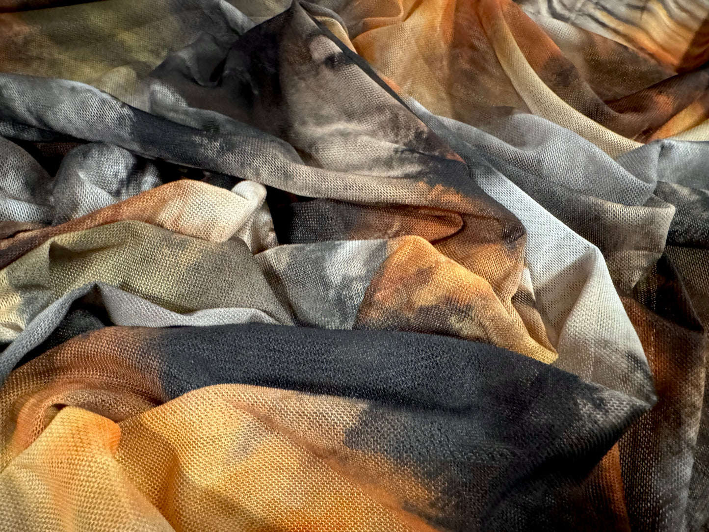 Power mesh net stretch spandex fabric, per metre - tie dye streak print - black orange and cream