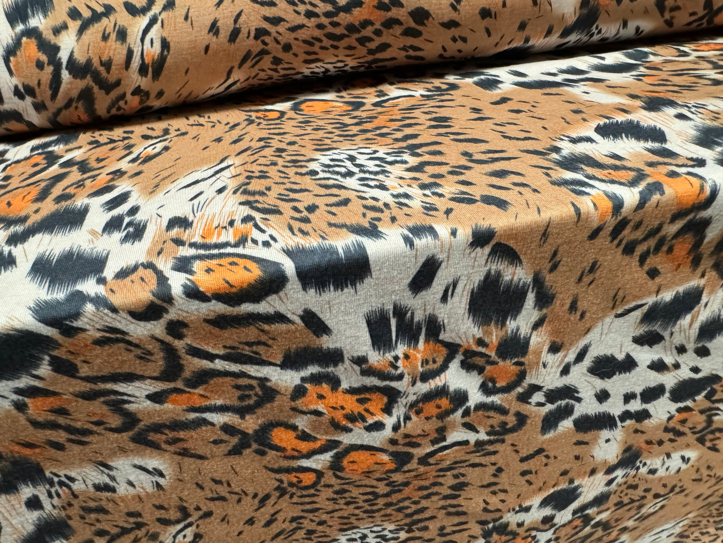 Soft handle stretch single jersey fashion fabric, per metre - stylised animal print - beige & orange