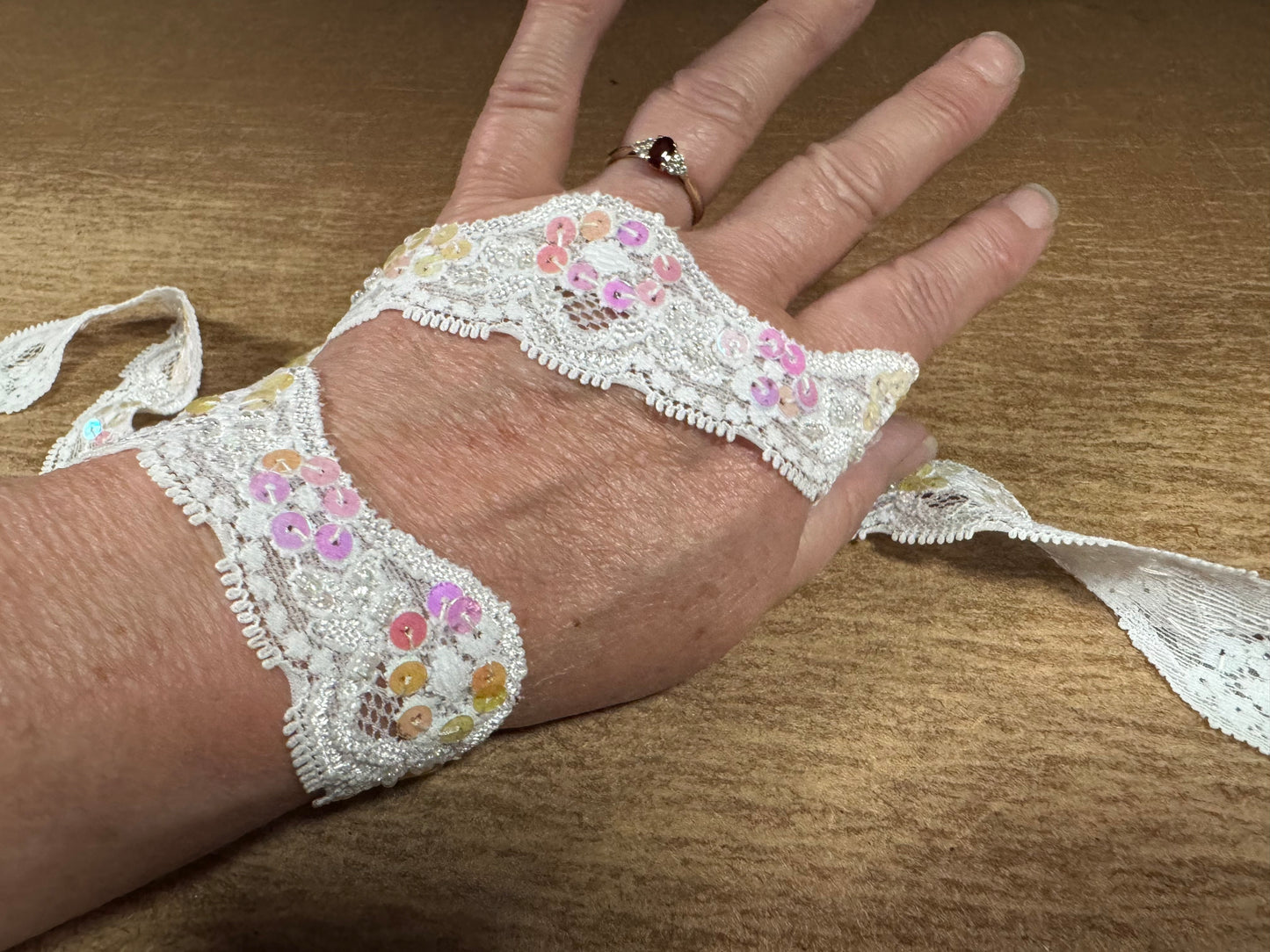 Scalloped lace edging trim fabric with sequins - stretch - paper white, pink & lilac