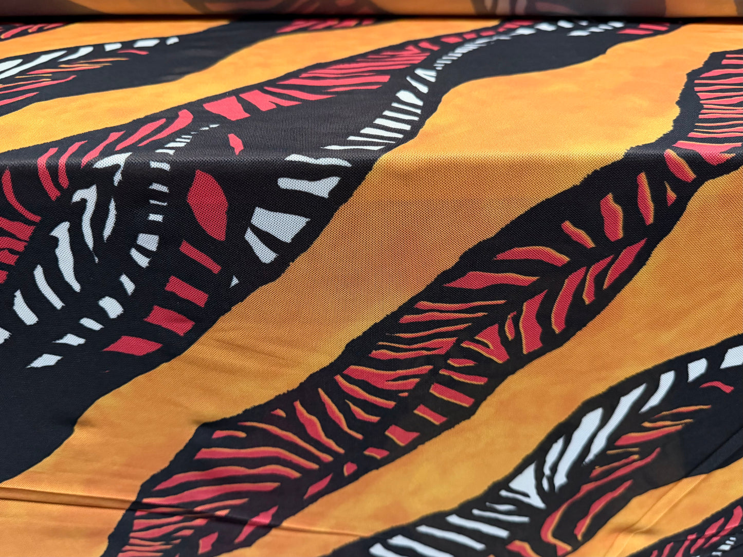 Power mesh net stretch spandex fabric, per metre - tribal print - amber