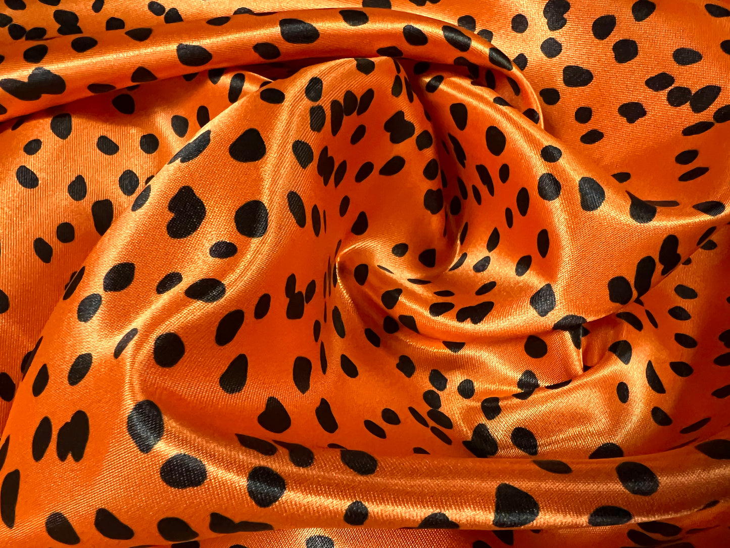 Silky Satin woven dress fabric, per metre - Dalmatian animal print - orange & black