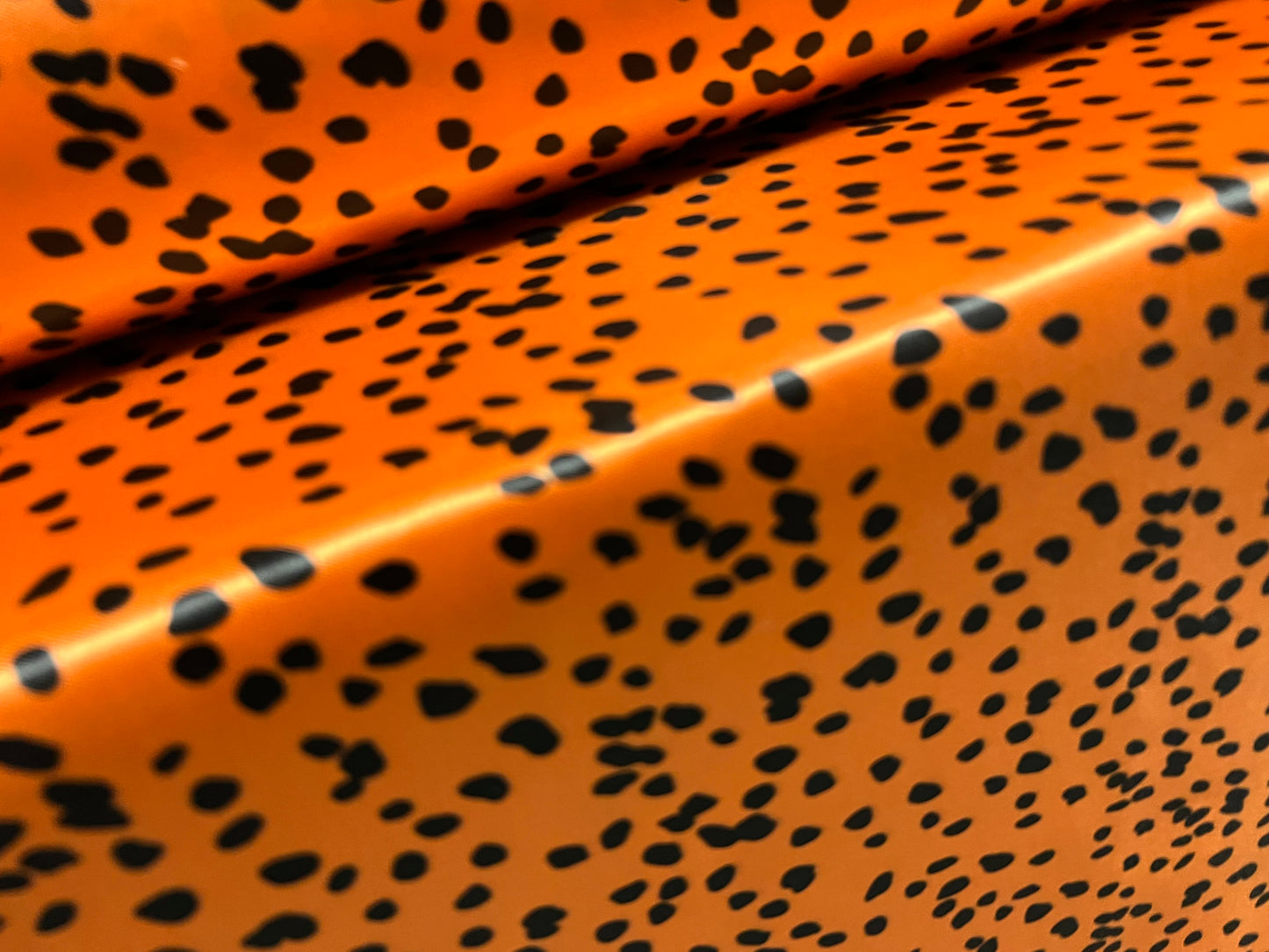 Silky Satin woven dress fabric, per metre - Dalmatian animal print - orange & black