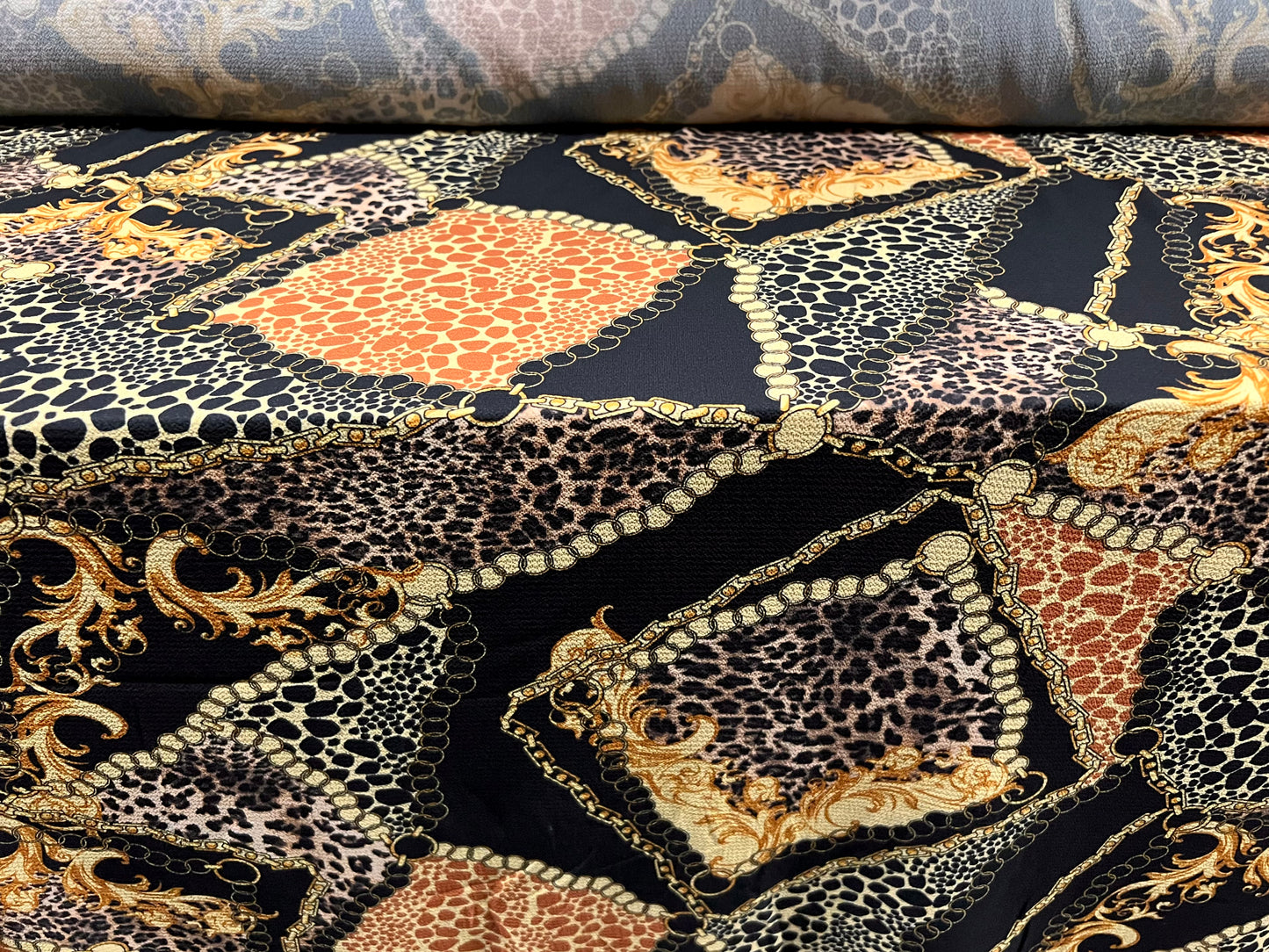 Bubble crepe stretch woven dress fabric, per metre - designer chains and leopardskin print - black & gold