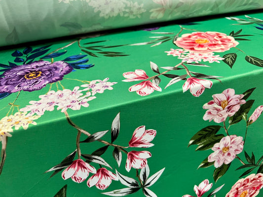 Soft touch stretch spandex jersey fabric, per metre - green with multicoloured flowers print