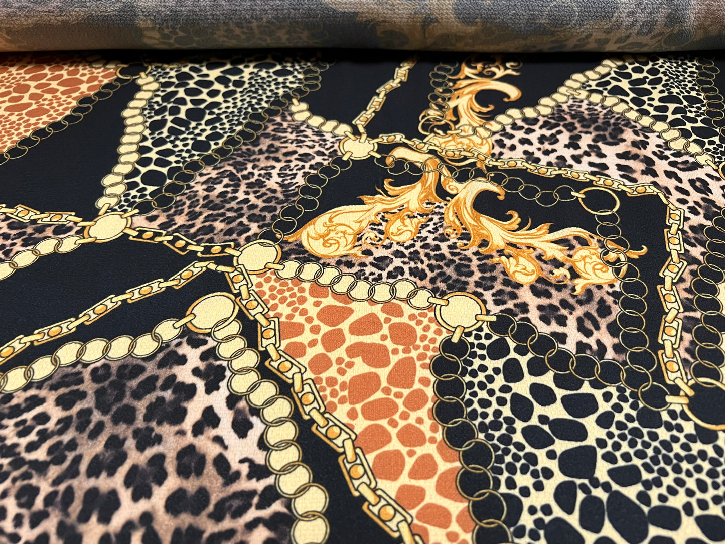 Bubble crepe stretch woven dress fabric, per metre - designer chains and leopardskin print - black & gold