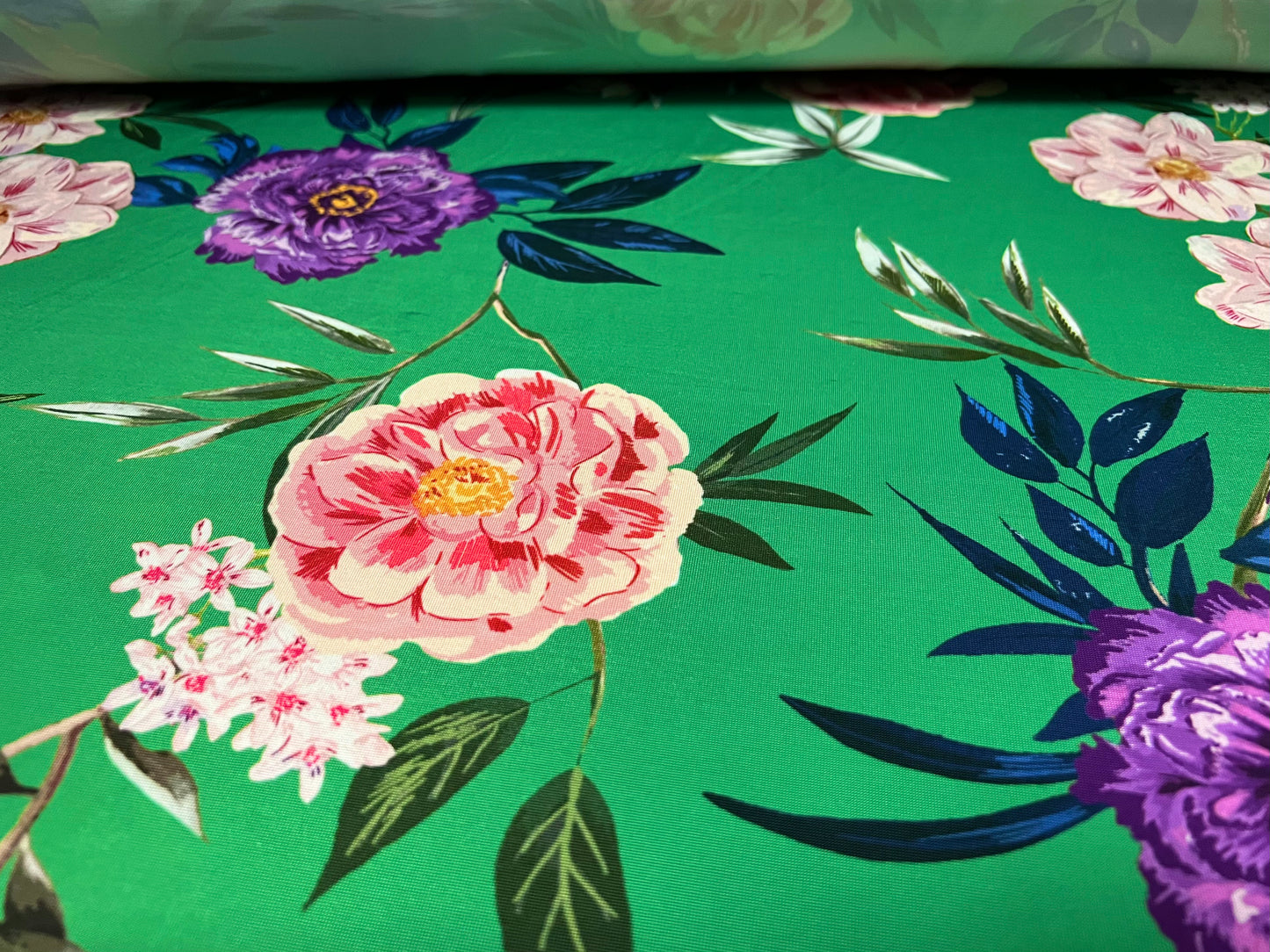 Soft touch stretch spandex jersey fabric, per metre - green with multicoloured flowers print