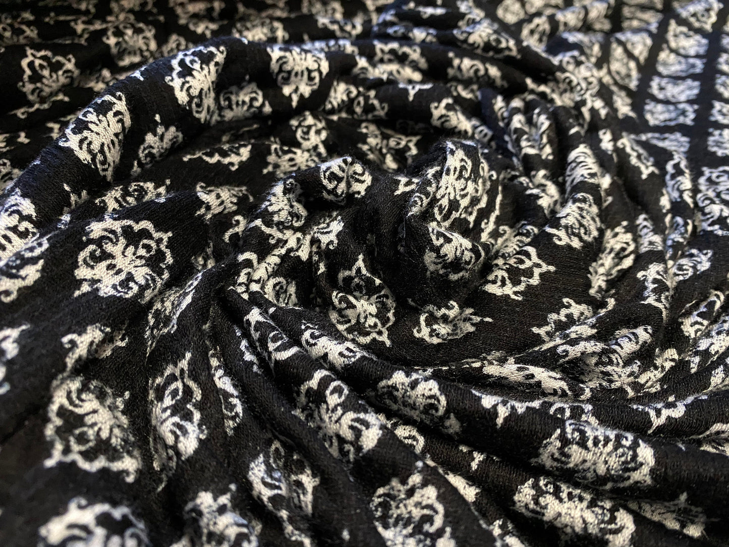 Floral printed seersucker jersey dress fabric, per metre - black and white flour de lys