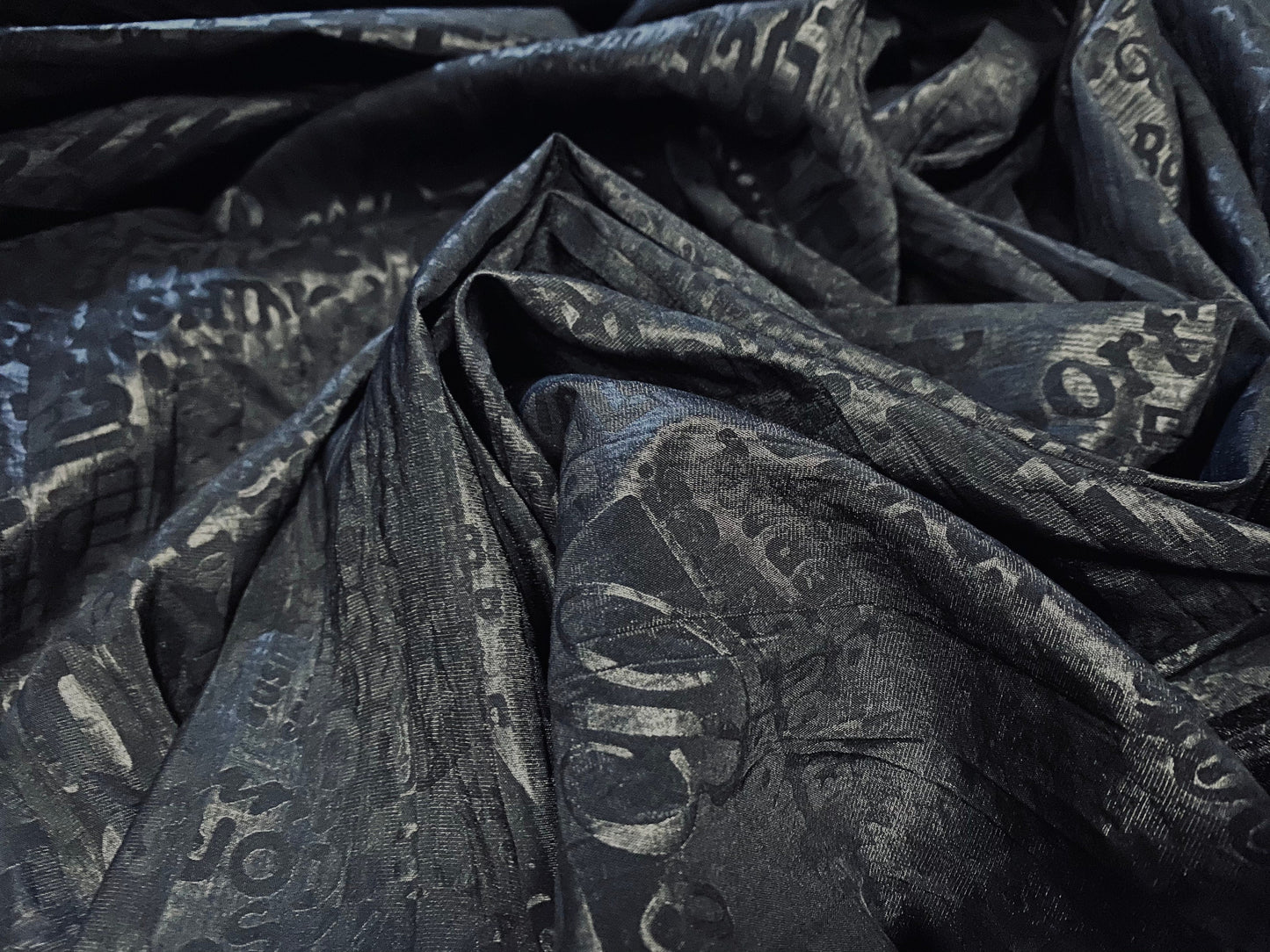 Crinkle woven dress fabric per metre, embossed fashion headlines print - black