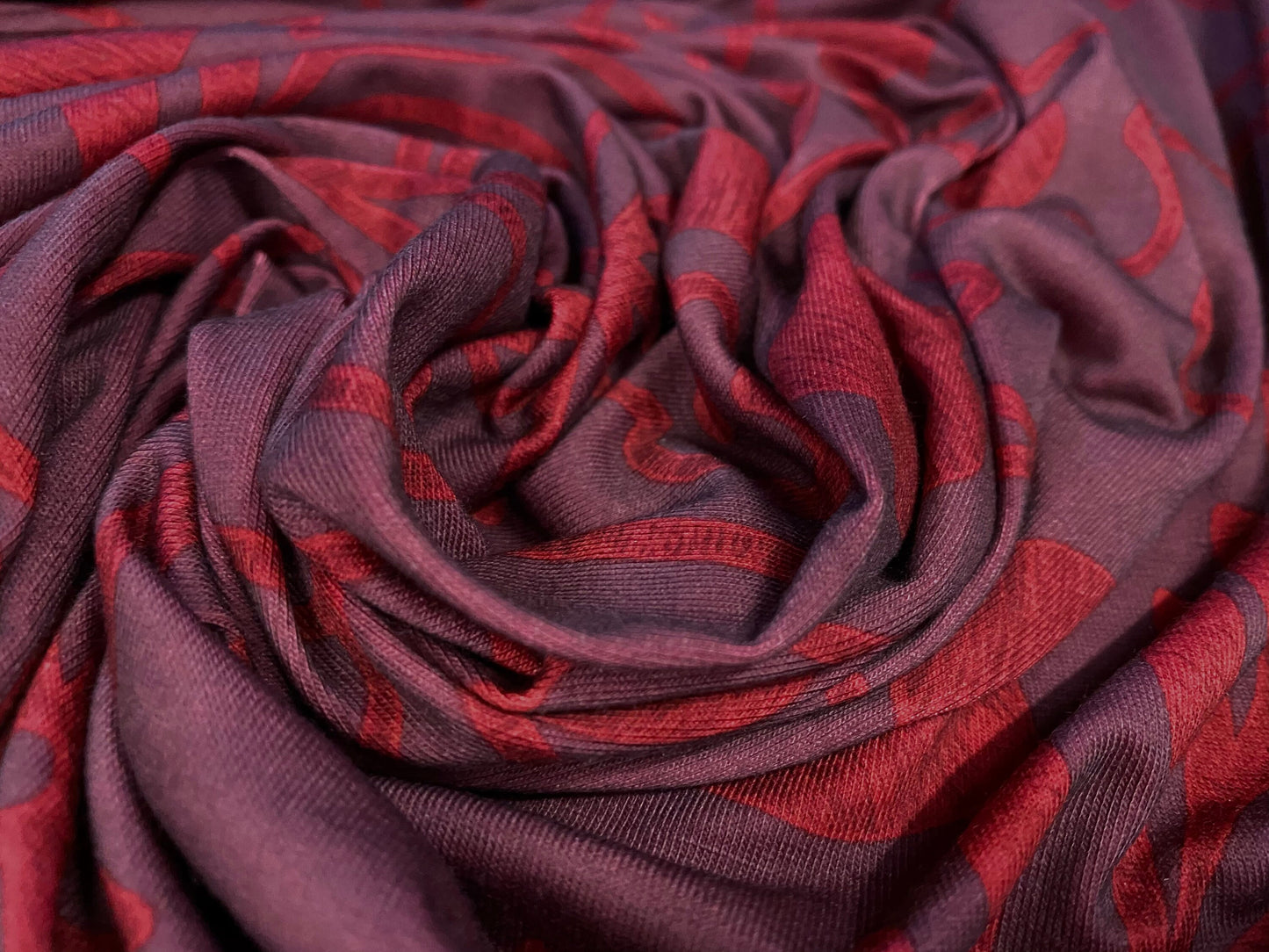 Soft handle jersey dress  fabric, per metre - dark aubergine with red flower print