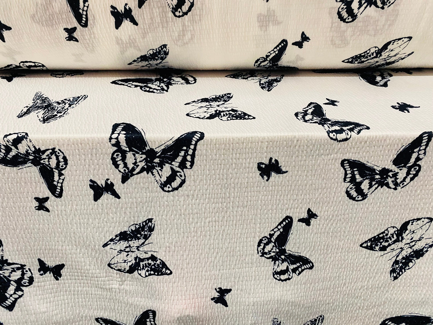 Textured lightweight single jersey dress fabric, per metre - white with black butterfly print - monochrome