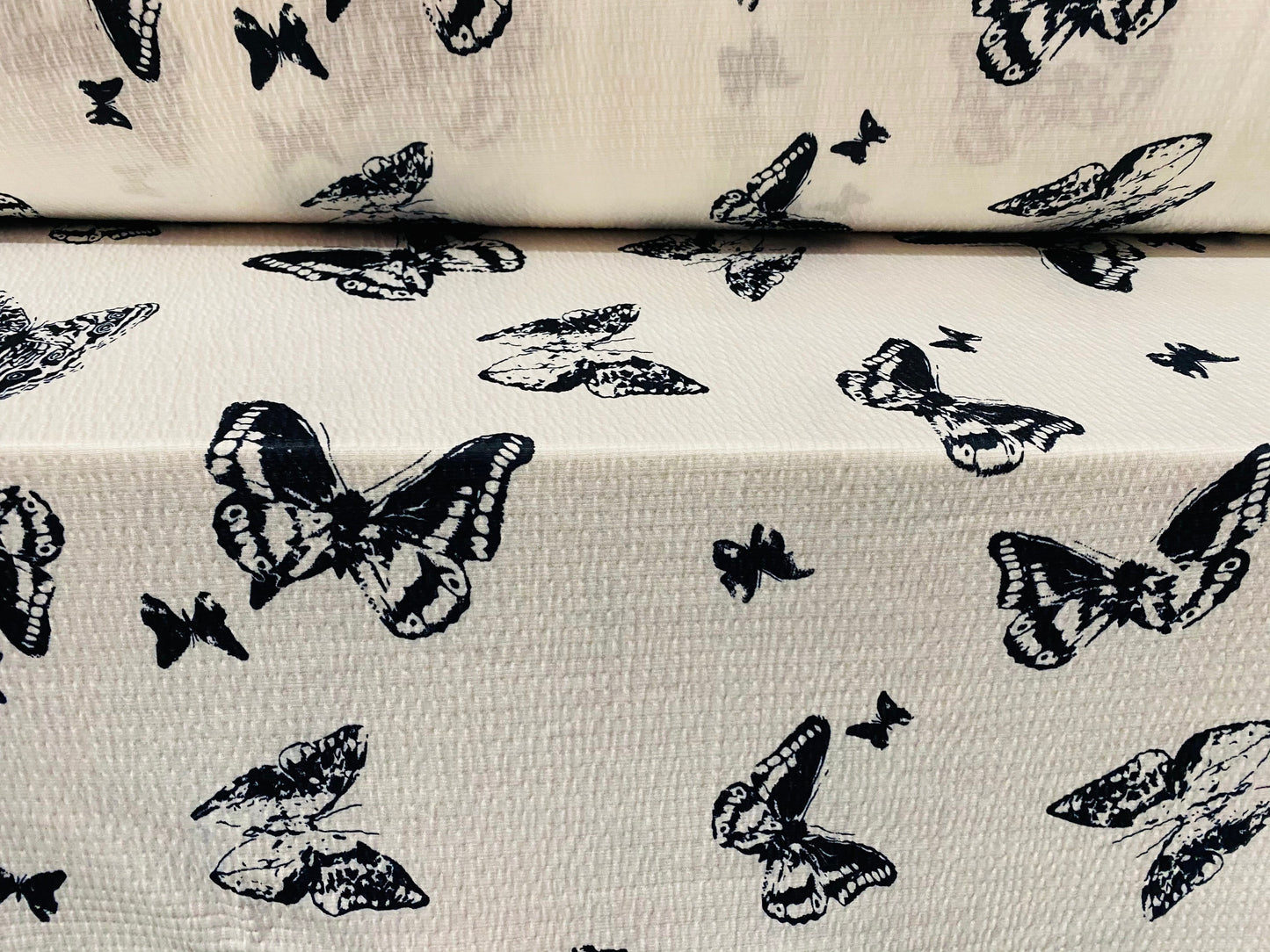 Textured lightweight single jersey dress fabric, per metre - white with black butterfly print - monochrome