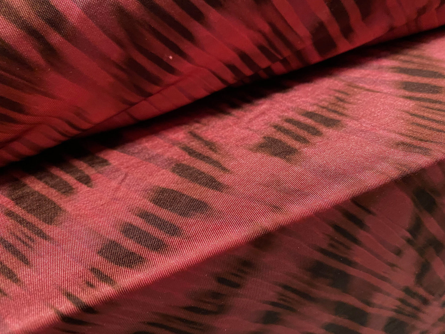 Disco shimmer stretch jersey fabric, per metre - stylised animal print - fuschia