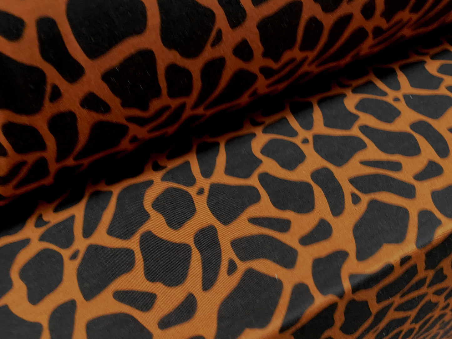 Soft handle jersey fabric, per metre - giraffe animal print - orange & black