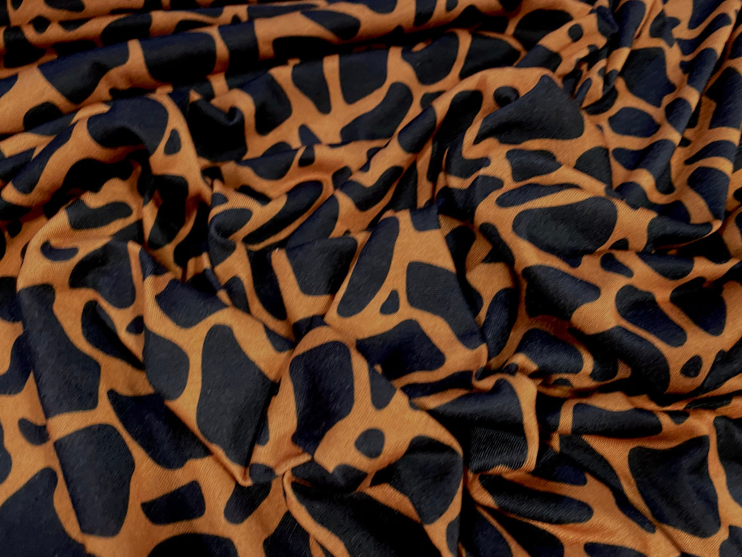 Soft handle jersey fabric, per metre - giraffe animal print - orange & black