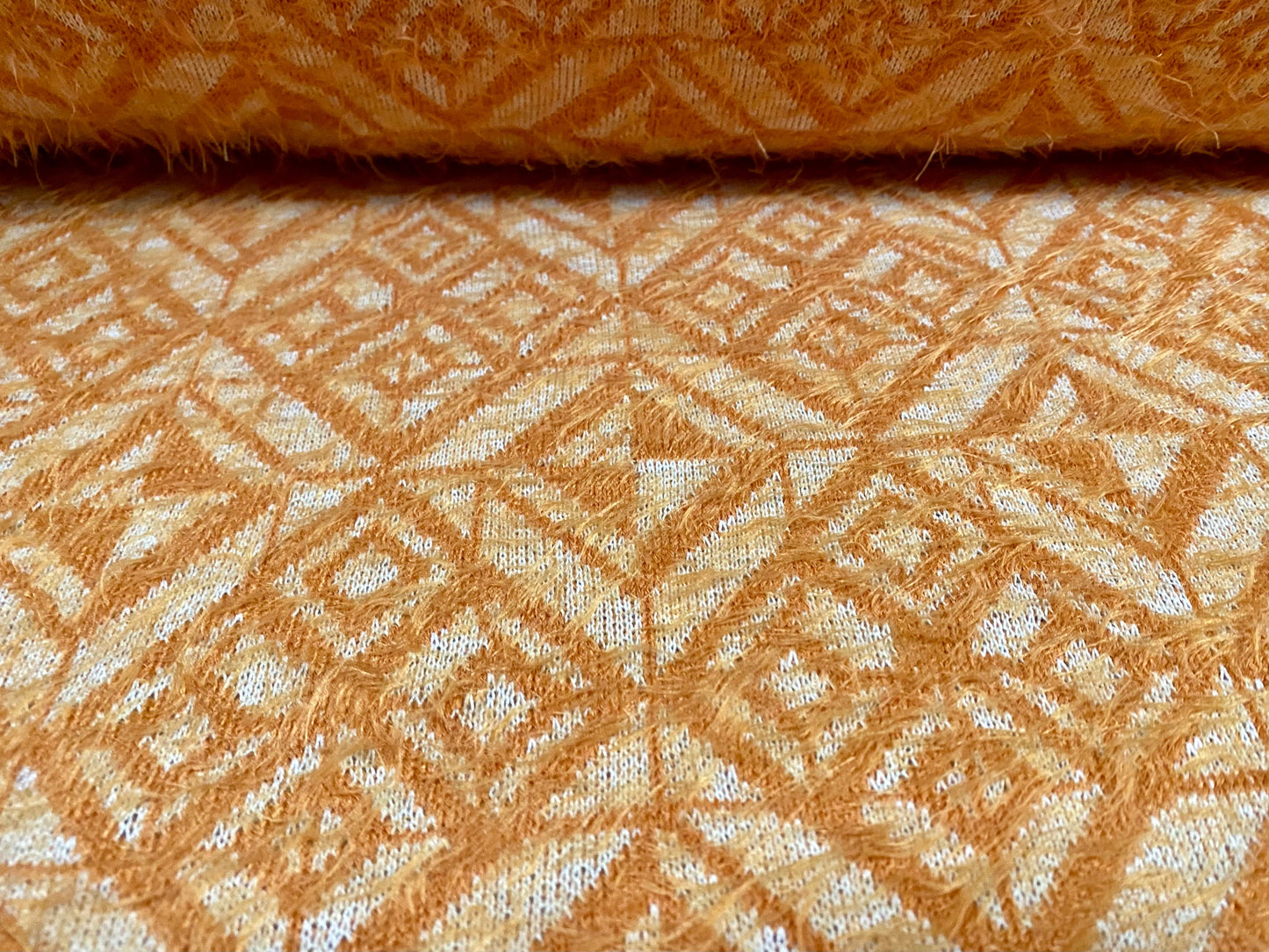 Soft hairy mohair style knitwear jersey fabric, per metre - geometric jacquard - Orange