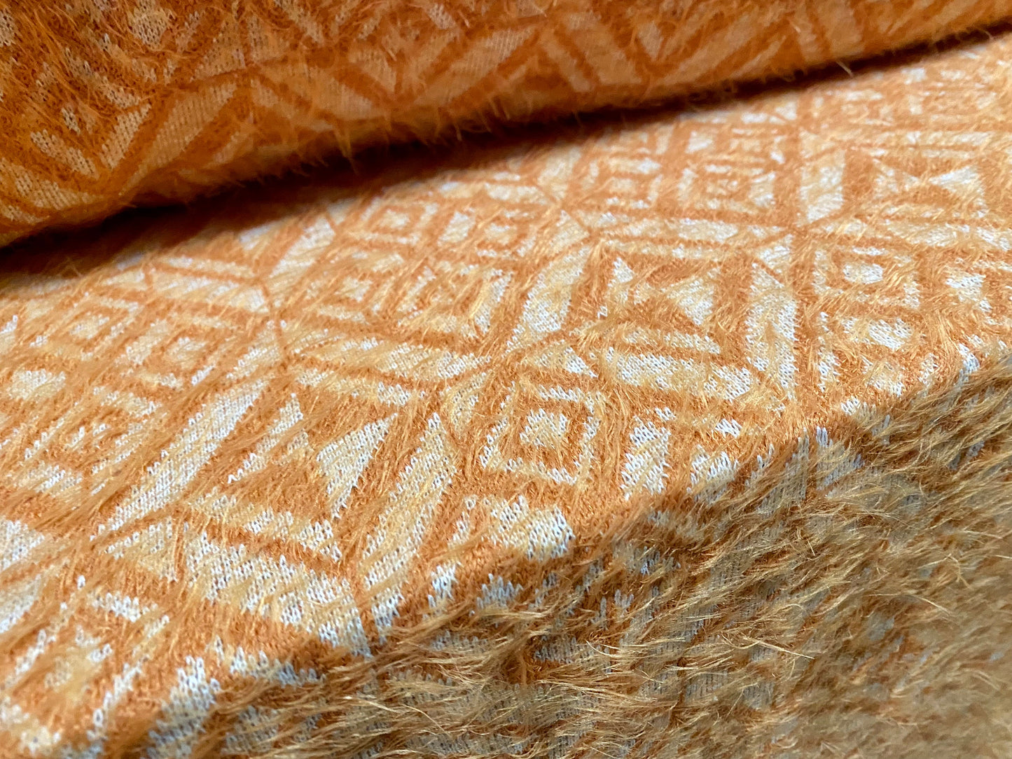 Soft hairy mohair style knitwear jersey fabric, per metre - geometric jacquard - Orange