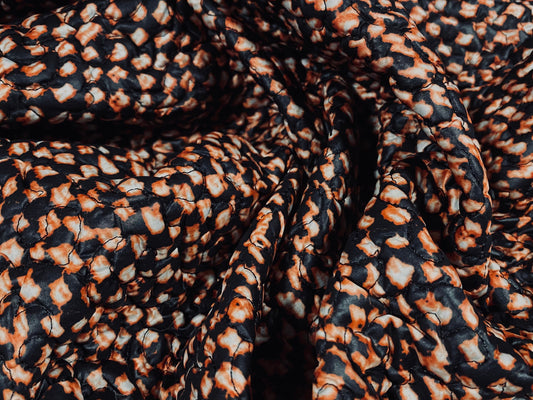 Quilted coat jacket fabric, per metre - distressed animal print - black & rust