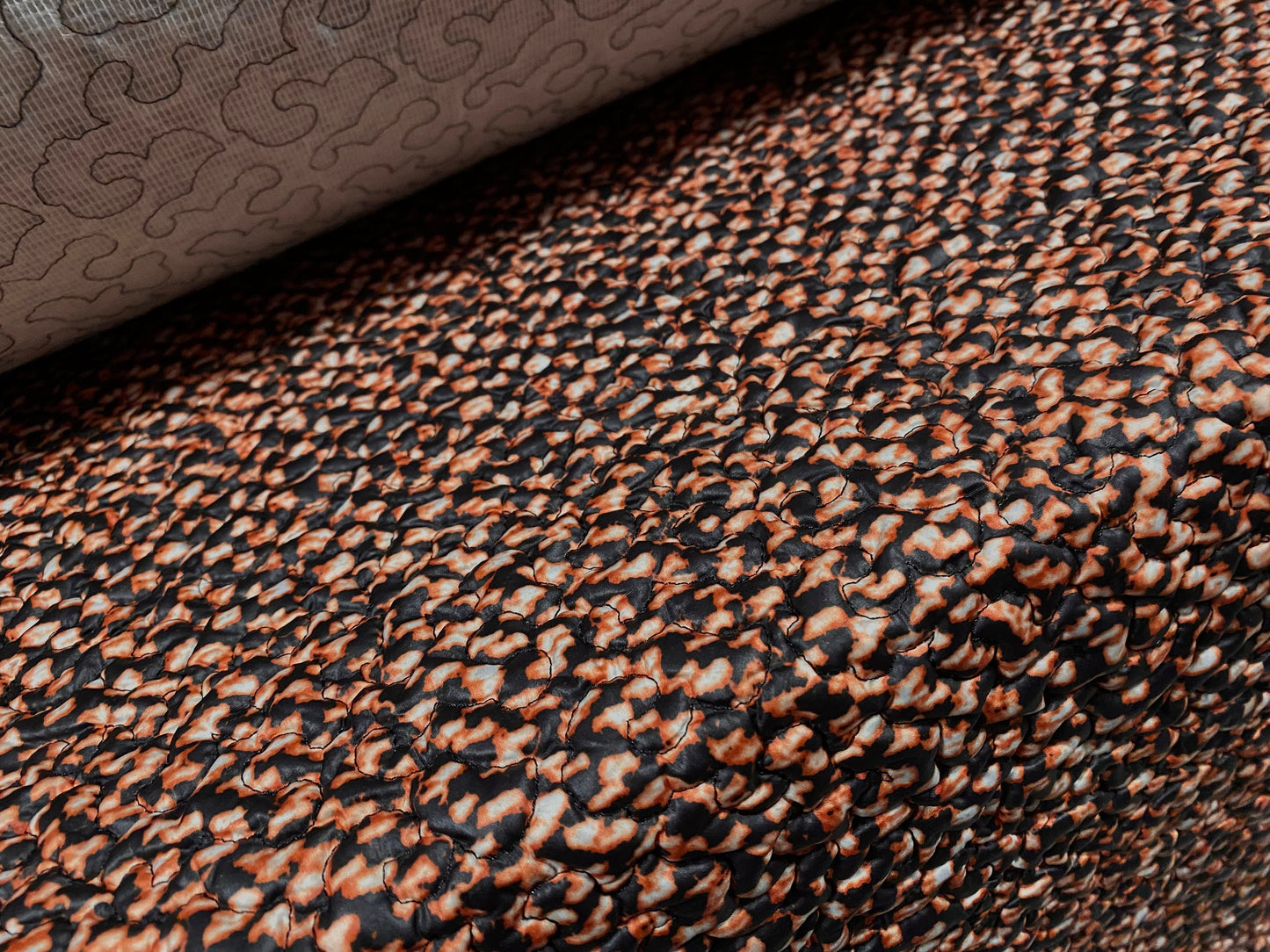 Quilted coat jacket fabric, per metre - distressed animal print - black & rust