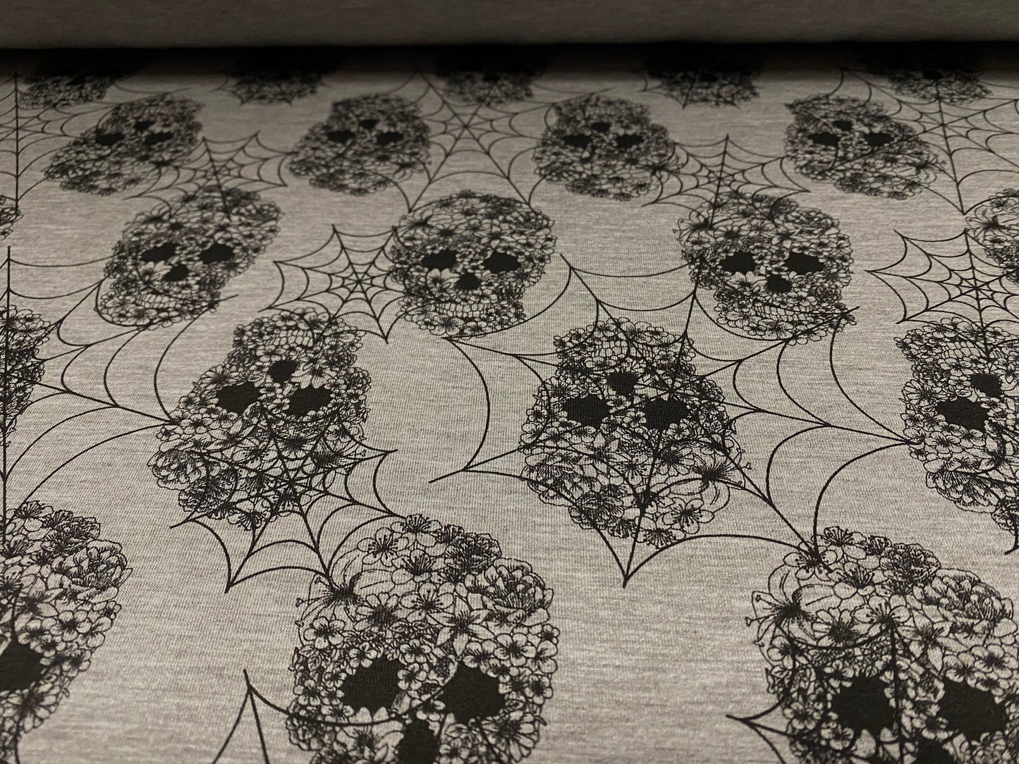 Single jersey dress fabric, per metre - floral skulls and cobwebs print - grey marl