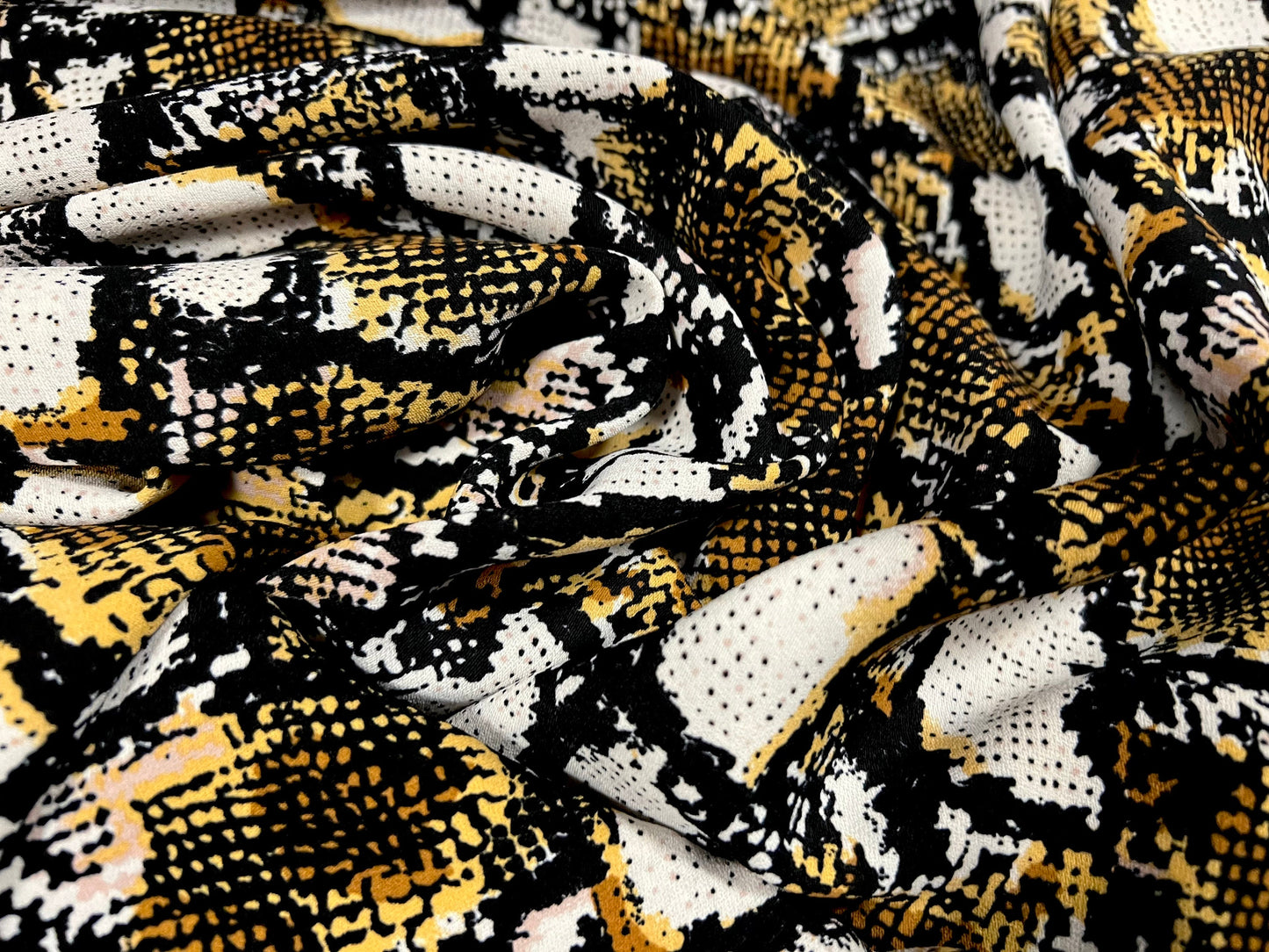 Peachskin woven dress fabric, per metre - snakeskin animal print - white black & gold