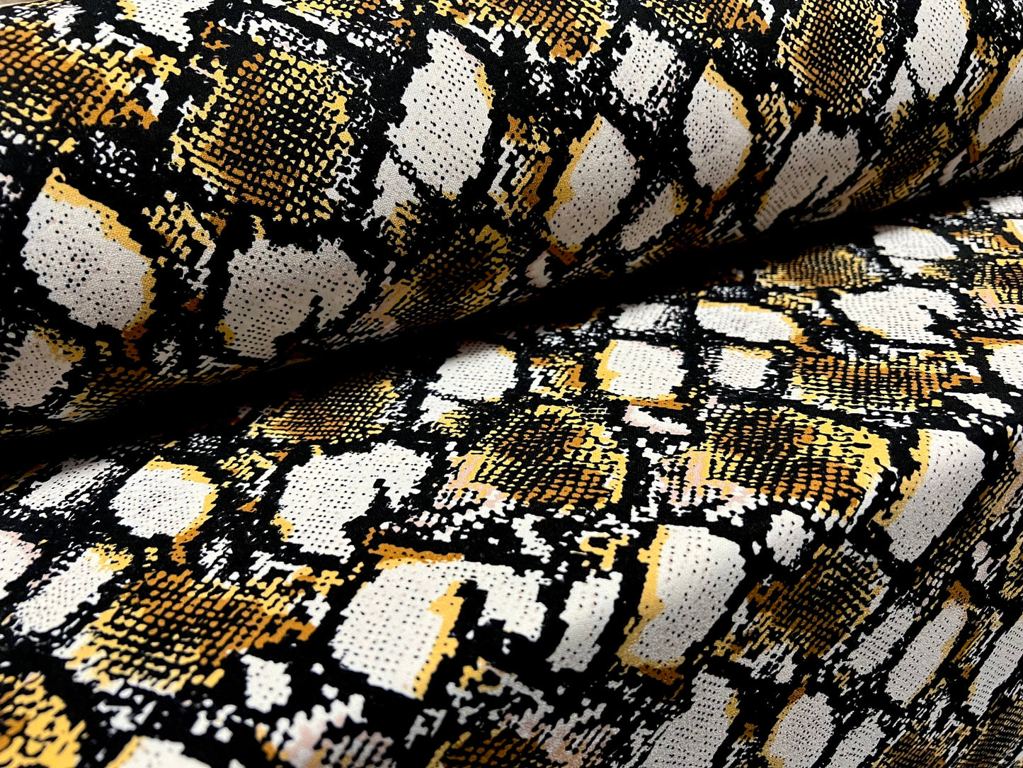 Peachskin woven dress fabric, per metre - snakeskin animal print - white black & gold