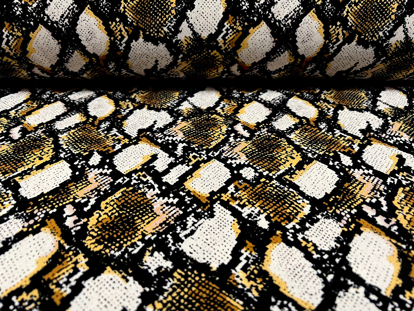 Peachskin woven dress fabric, per metre - snakeskin animal print - white black & gold