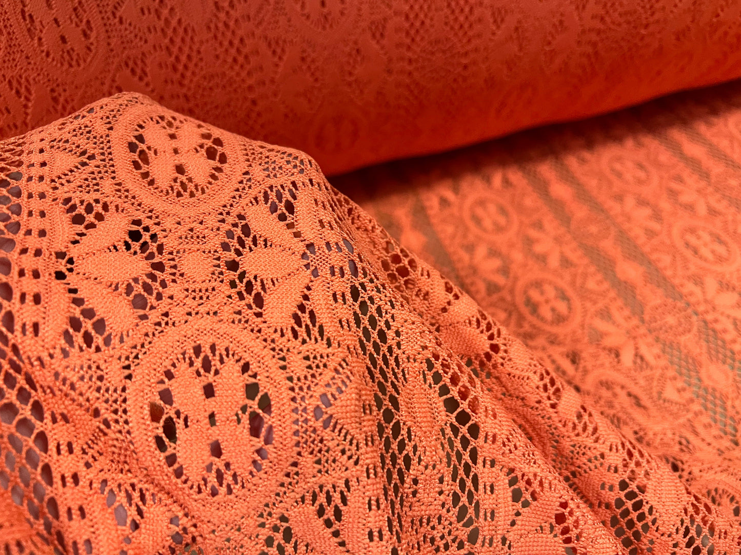 Soft handle crochet lace knit fabric, per metre - coral