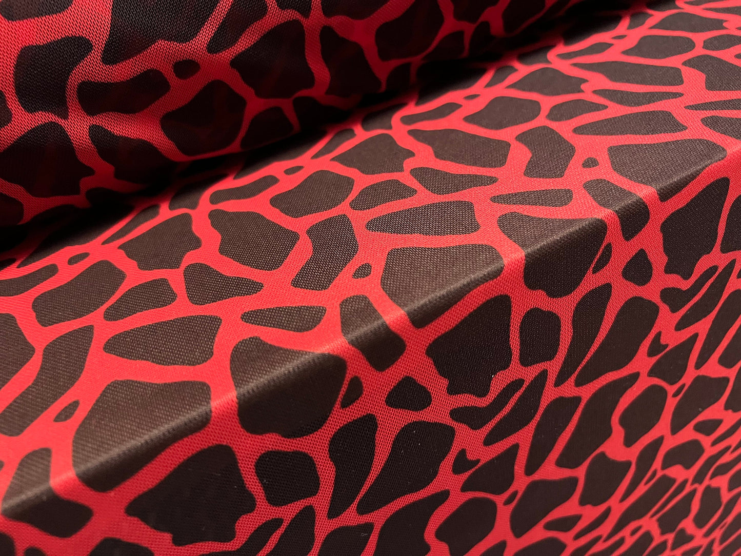 Power mesh net stretch spandex fabric, per metre - giraffe animal print - red & black