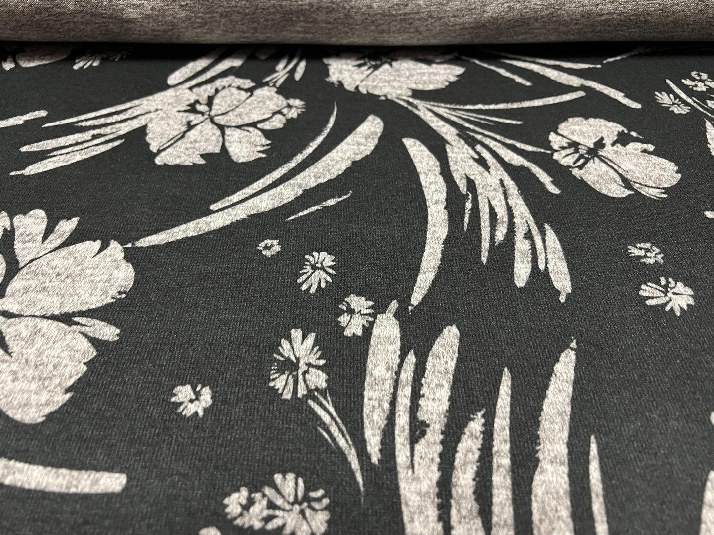 Super soft knitwear jersey fabric, per metre - stylised flower print - black & grey marl