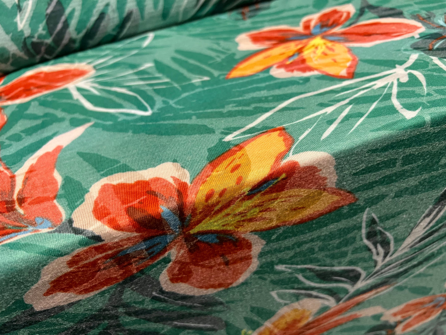 Lady K lightweight burnout single jersey fabric, per metre - leaves and lilies print - green & orange