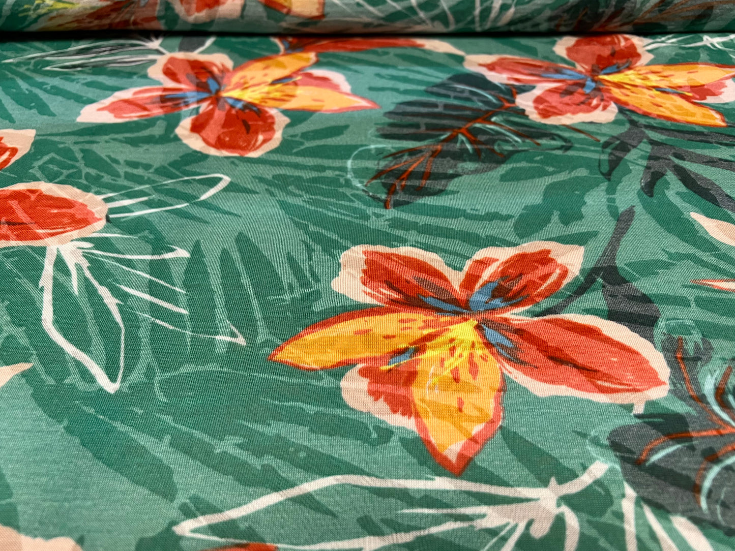 Lady K lightweight burnout single jersey fabric, per metre - leaves and lilies print - green & orange