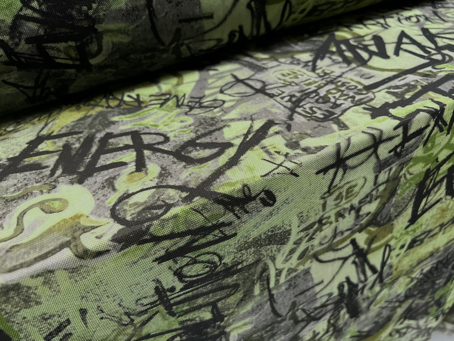 Power mesh net stretch spandex fabric, per metre - anarchy graffiti print - green