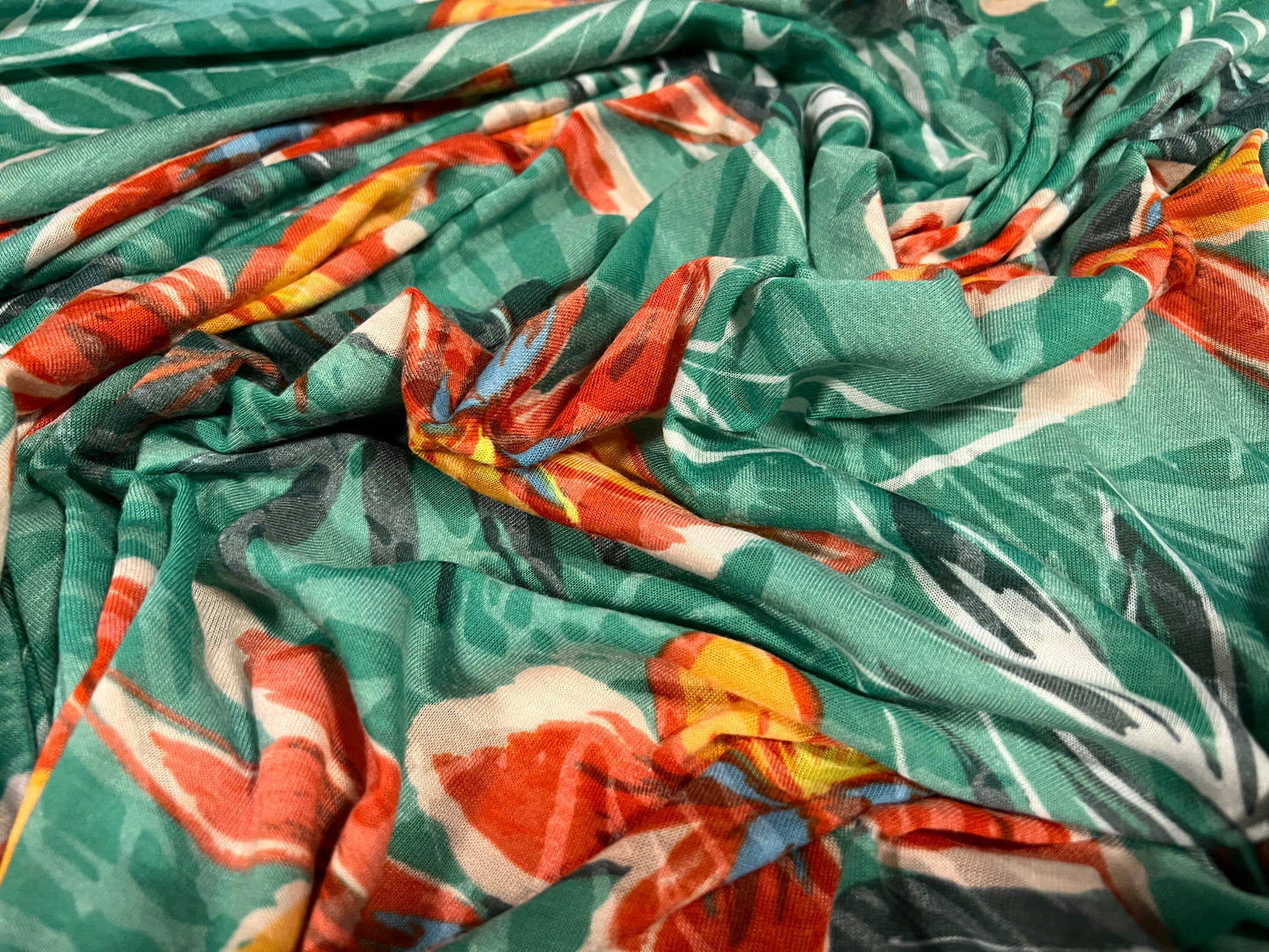 Lady K lightweight burnout single jersey fabric, per metre - leaves and lilies print - green & orange